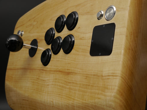 Close-up of the Rock Maple top from stct8r Normals line. The Sega Six layout includes a Sanwa JLF lever and six Sanwa OBSN30 buttons in their classic curved configuration. Stainless steel ancillary buttons are LED illuminated. LCD bezel is magnetically attached.