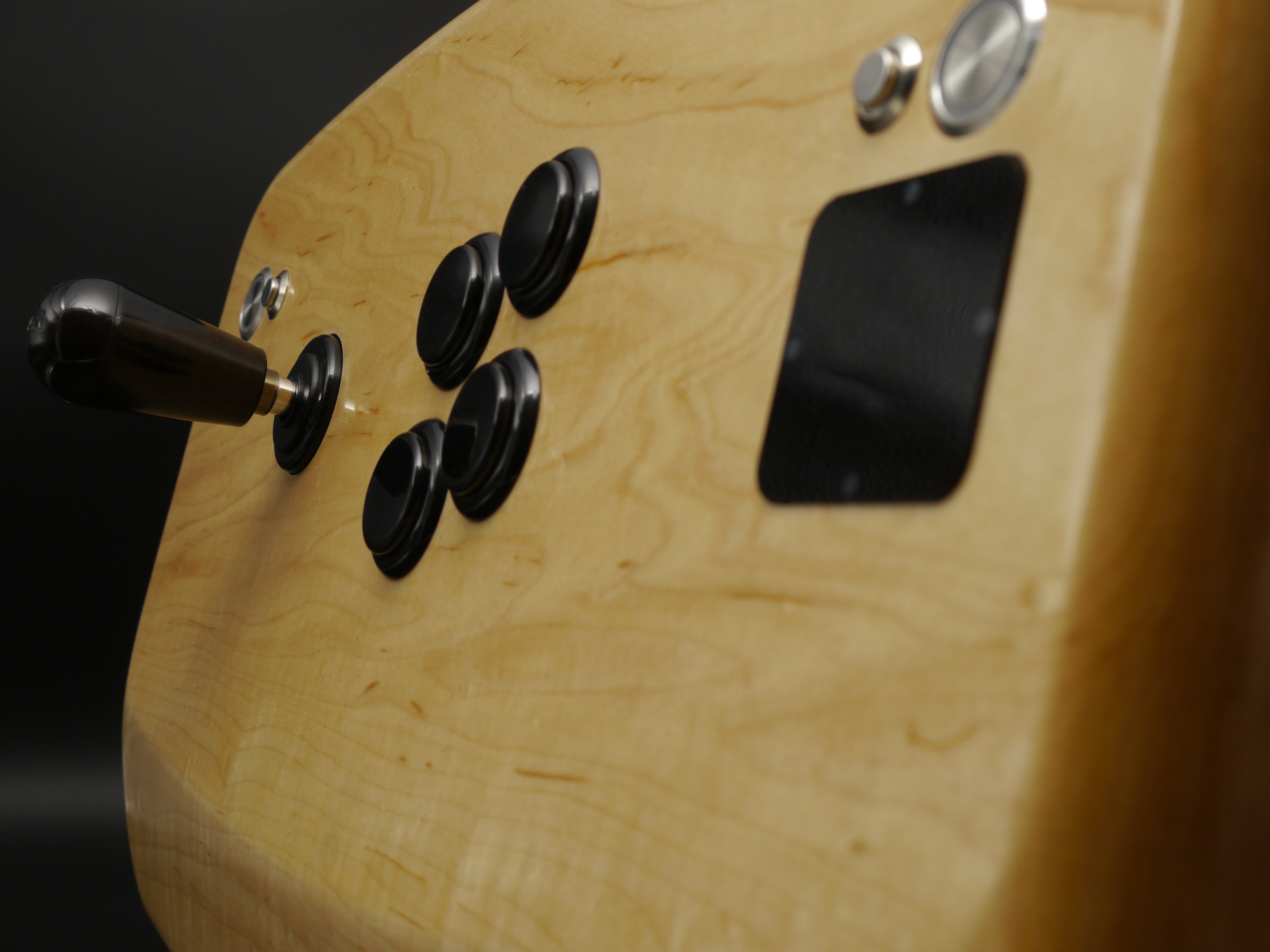 Close-up of the Rock Maple top from stct8r Normals line. The Seoul Brother layout is a hybrid layout that includes a Crown 309K lever and four Sanwa OBSN30 buttons in the Namco Noir configuration. Stainless steel ancillary buttons are LED illuminated. LCD bezel is magnetically attached.